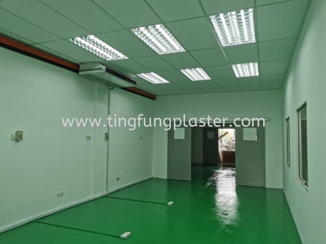 Interior after being painted with green epoxy floor, freshly painted walls, and new ceiling lighting