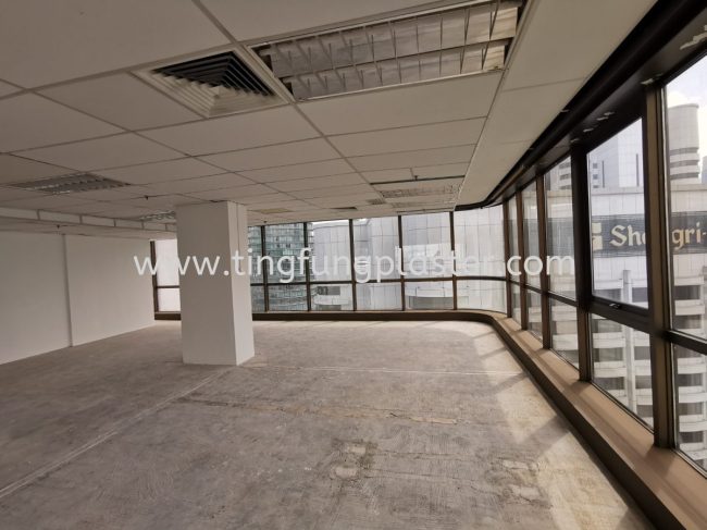 Office space with removed ceiling panels and scattered debris during reinstatement teardown.