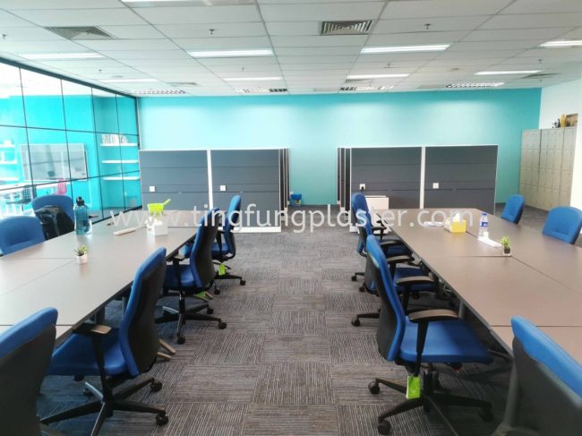 Office area with tables, chairs, and partitions