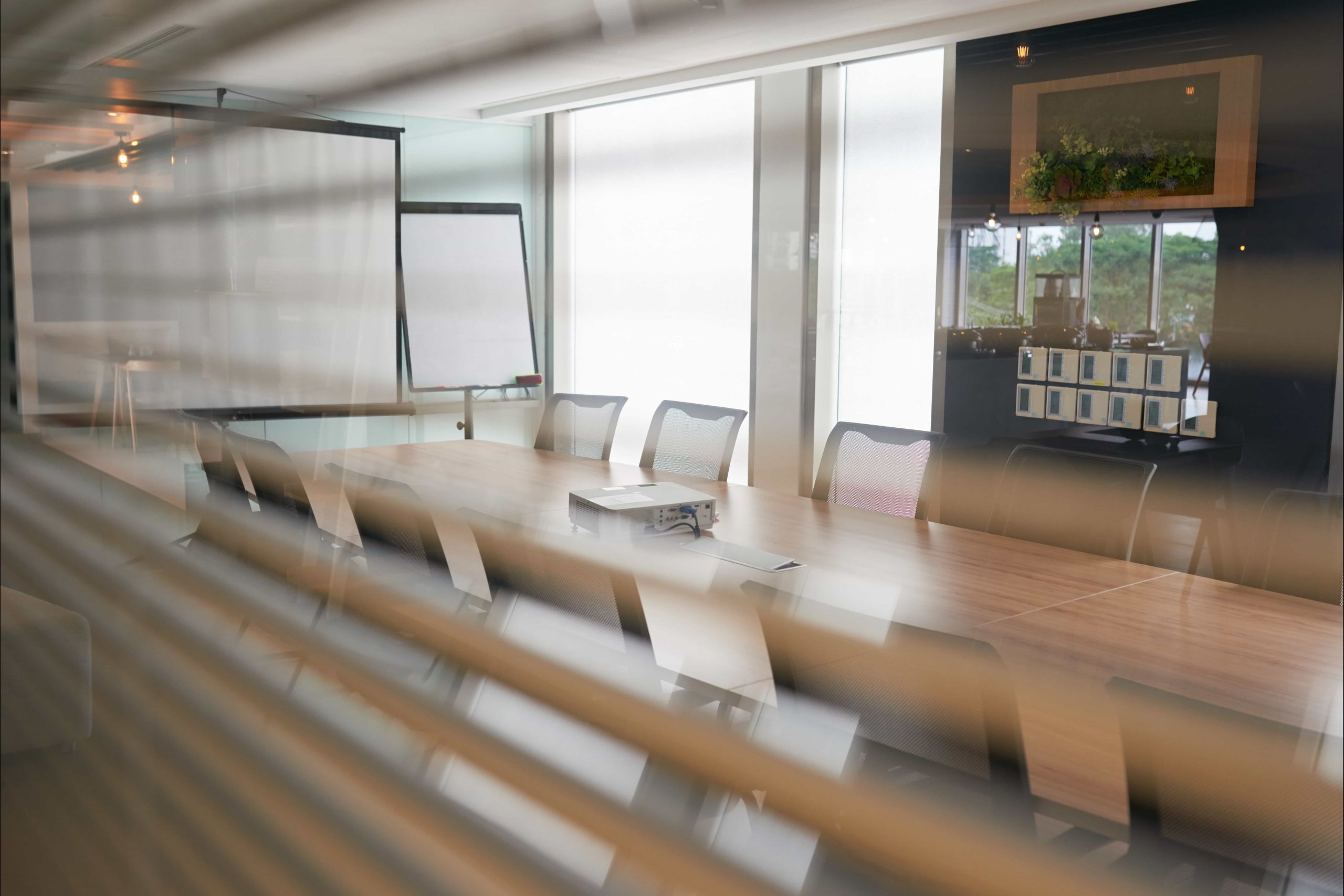 Modern office meeting room with glass partition walls and natural light