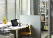 Workspace with partition walls and a simple desk setup