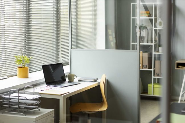 Workspace with partition walls and a simple desk setup